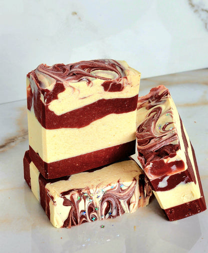 Marbled red and white soap bars on a marble surface